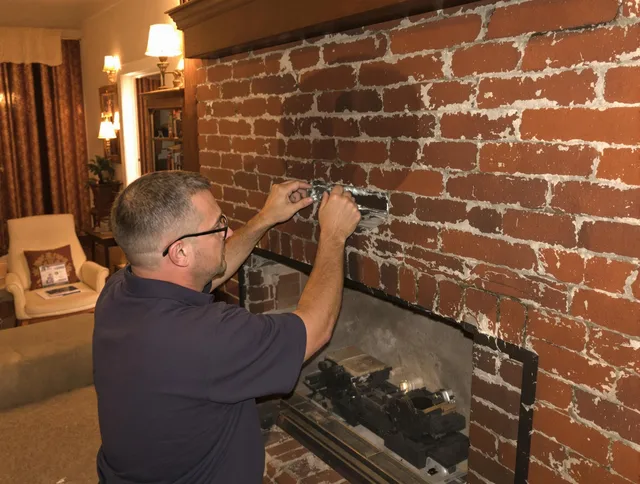 Garfield Heights Chimney Sweep expert fixing a fireplace in Garfield Heights, OH